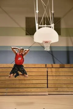 Basketball player dunking ball Stock Photos