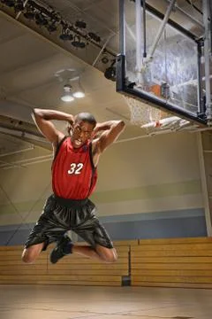 Basketball player dunking ball Stock Photos