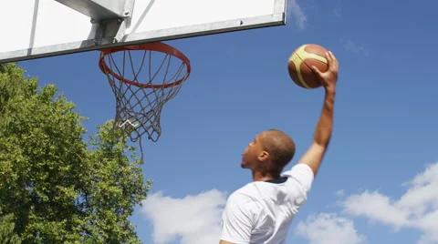 Basketball player elevates to slam dunk and score, in slow motion Stock Footage 67370613