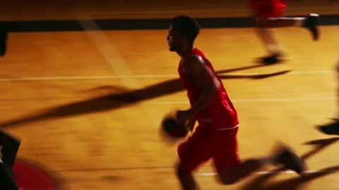 A basketball player makes a basket during a game Stock Footage 70684027