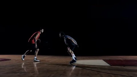 A basketball player makes a move on defender and dunks the ball. Stock Footage 83608272