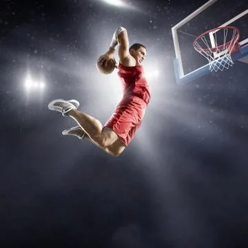 Basketball player makes slam dunk Stock Photos