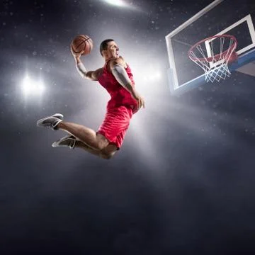 Basketball player makes slam dunk Stock Photos