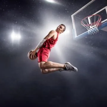 Basketball player makes slam dunk Stock Photos