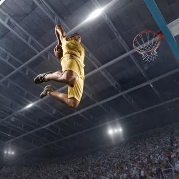 Basketball player makes slam dunk Stock Photos