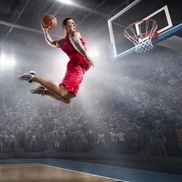 Basketball player makes slam dunk Stock Photos
