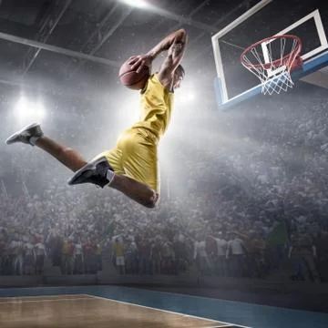 Basketball player makes slam dunk Stock Photos