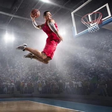Basketball player makes slam dunk Foto stock
