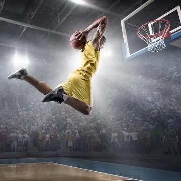 Basketball player makes slam dunk Stock Photos