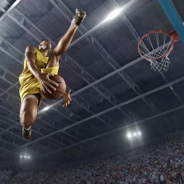 Basketball player makes slam dunk Stock Photos