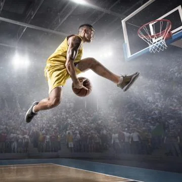 Basketball player makes slam dunk Stock Photos
