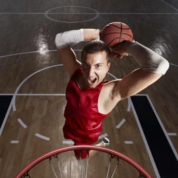Basketball player makes slam dunk Stock Photos