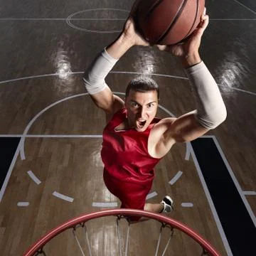 Basketball player makes slam dunk Stock Photos