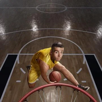 Basketball player makes slam dunk Stock Photos