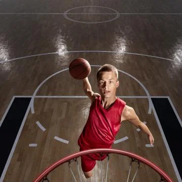 Basketball player makes slam dunk Stock Photos