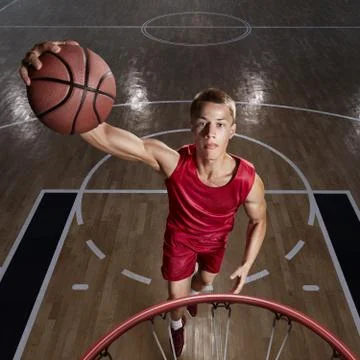 Basketball player makes slam dunk Stock Photos