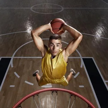 Basketball player makes slam dunk Stock Photos