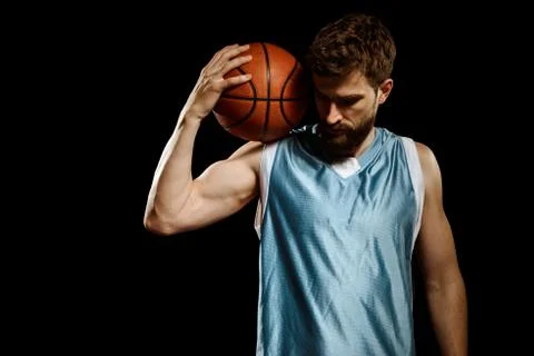 Basketball player posing with ball over black background Stock Photos
