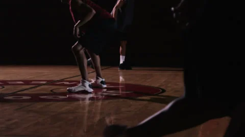 A basketball player runs down the court past defenders and then scores Stock Footage