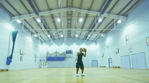 Basketball player scoring a 3 point jump shot whilst practicing alone Video stock 46202192