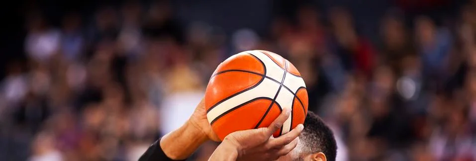 Basketball player shooting three pointer Stock Photos