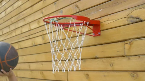 Basketball player throws the ball into the basket from under the basket. Stock Footage 208015378