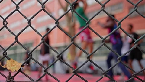 A basketball player throws the ball into the basket. Basketball on the street Stock Footage 256237877