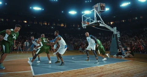 Basketball players on big professional arena during the game Stock Footage