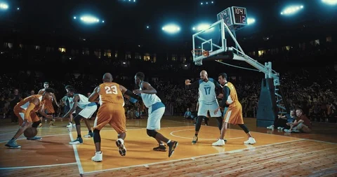Basketball players on big professional arena during the game Stock Footage