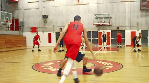 Basketball players passing the ball down the court Stock Footage 70685755