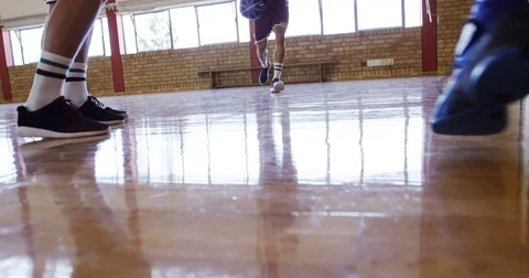 Basketball players playing in the court Stock Footage