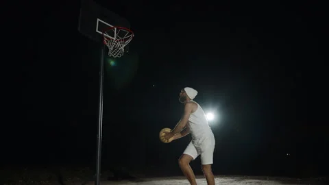 Basketball practice at night in the park showcasing skills outdoors Video stock 293245320