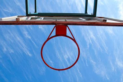 Basketball ring on the background a blue sky with white clouds. Basketball hoop Stock Photos