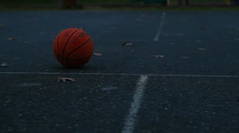Basketball Rolling Across Screen On A Cloudy Day Stock Footage 33849680
