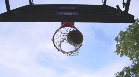 A basketball stuck in a torn net gets knocked out Video stock 40361244
