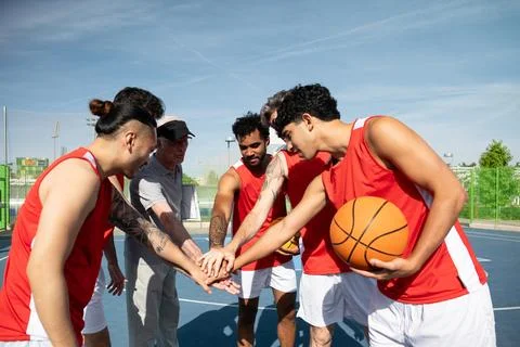 Basketball team huddle showing unity and strategy plan Stock Photos