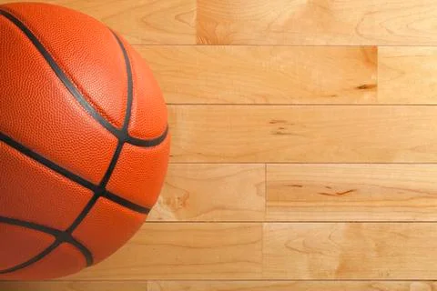Basketball on wood gym floor viewed from above Stock Photos