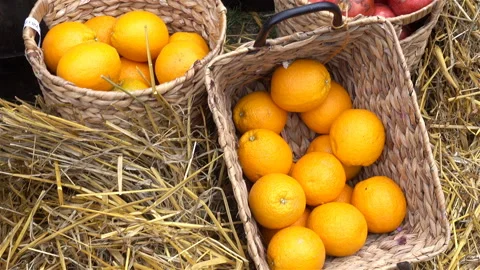 Baskets with ripe oranges stand on a straw. Stock Footage 120731664