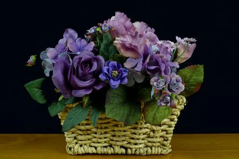 Baskewt of flowers on a black back ground Stock Photos