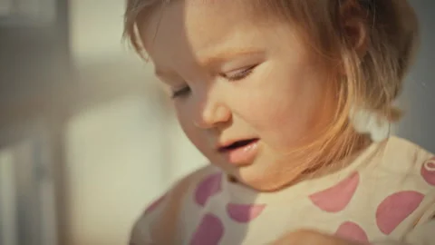 Basking warm sunlight curious little girls face lights up with smile as she Stock Footage 331866537
