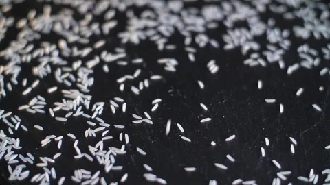 Basmati rice is poured onto the stone surface. Slow motion Stock Footage 80325382