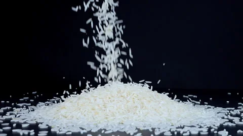 Basmati white rice falling on a black background Stock Footage 261064245