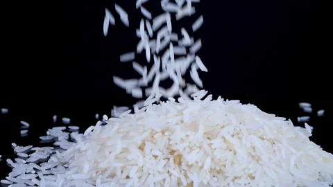 Basmati white rice falling on a black spinning background Video stock 261064266