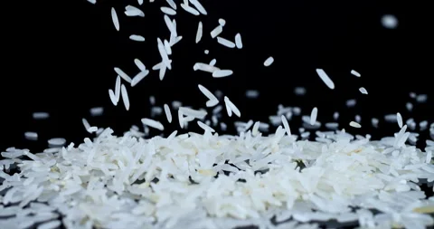 Basmati white rice falling on a black spinning background Stock Footage 261064721