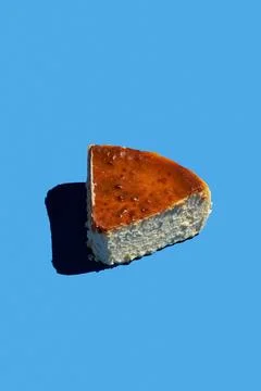 Basque cheesecake on blue background with hard shadow. The concept of a hea.. Stock Photos