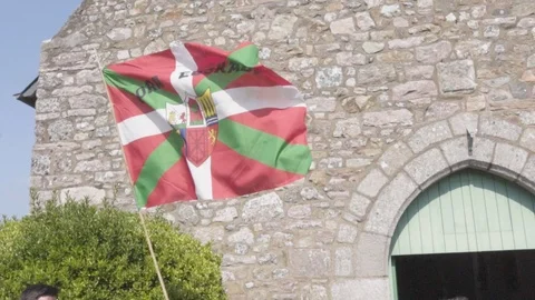 The basque flag in slow motion in front of a church Stock Footage 95815014