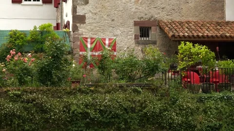 Basque flags hanging on a wall in the old town of Saint-Jean-Pied-de-Port. This Stock Footage 311608396