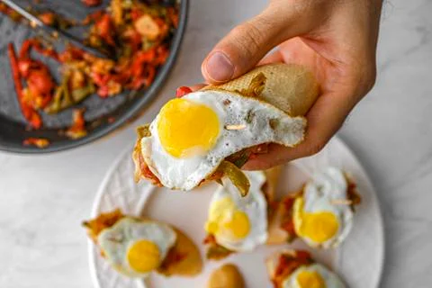 Basque pintxo made with onion, red &amp; green pepper topper with a small fried e Stock Photos