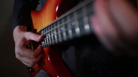 Bass guitar player close up playing virtuoso bass with fingers and slap Stock Footage