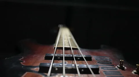 Bass guitar string vibrating. Close up. Black background. Stock Footage 49826695